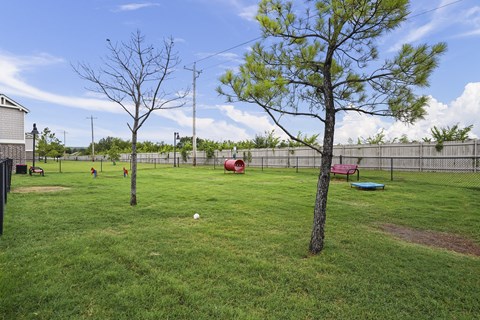 A baseball field with a red slide and a baseball in the middle of the field.