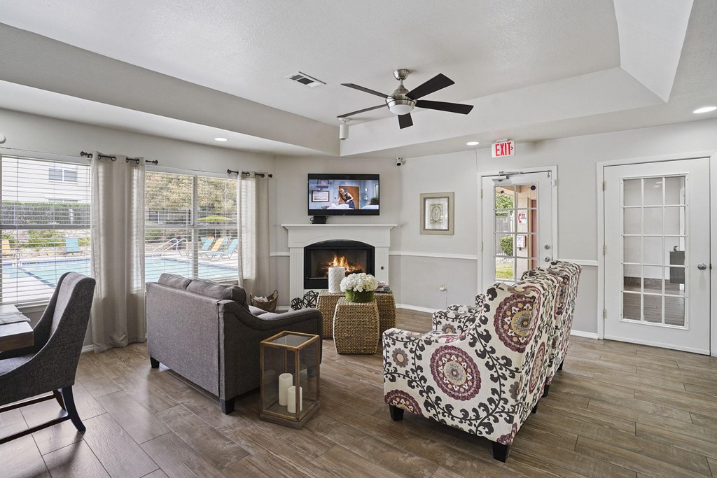 A living room with a fireplace, a chair, a couch, and a television.