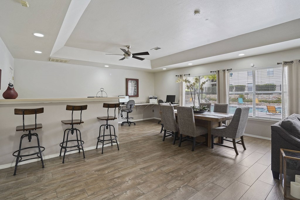 A room with a bar area and a dining table.
