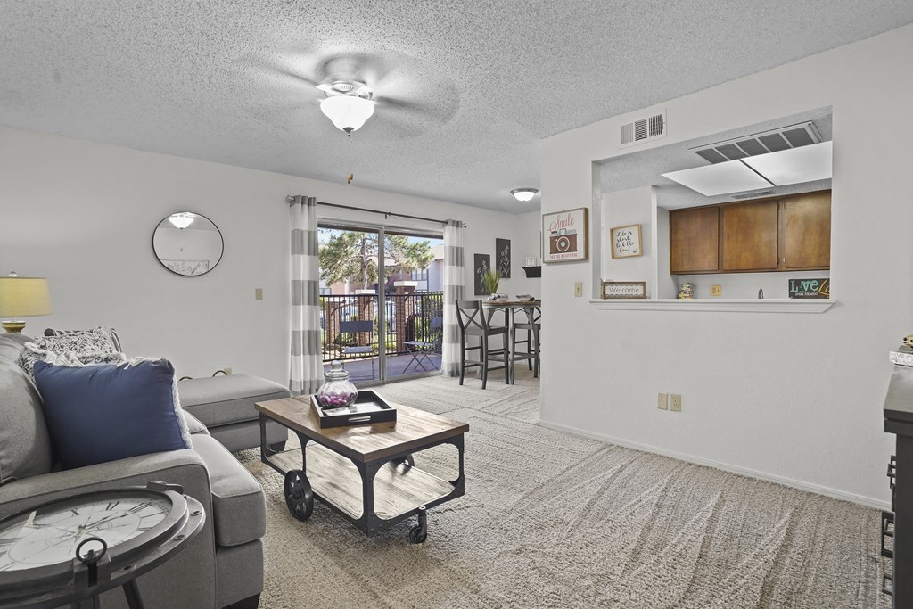 A living room with a grey couch and a coffee table.