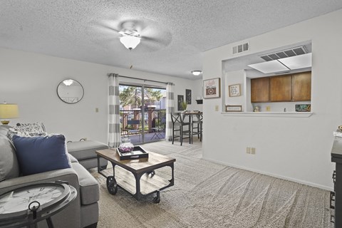 A living room with a grey couch and a coffee table.