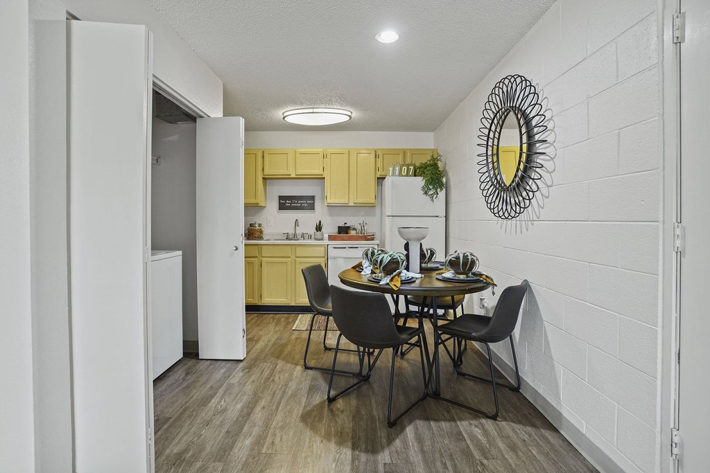A kitchen with a table and chairs in the middle of the room.