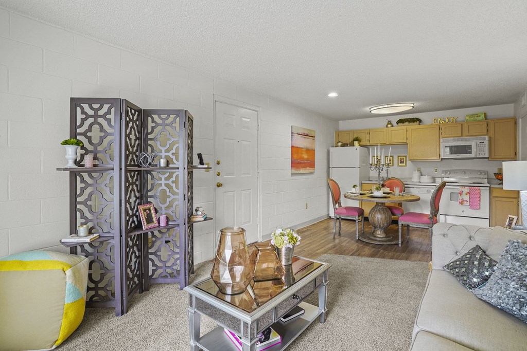 A living room with a white couch and a coffee table.