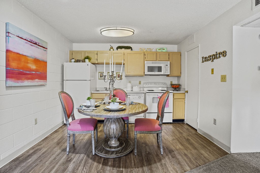 A kitchen with a table and chairs in the middle of the room.