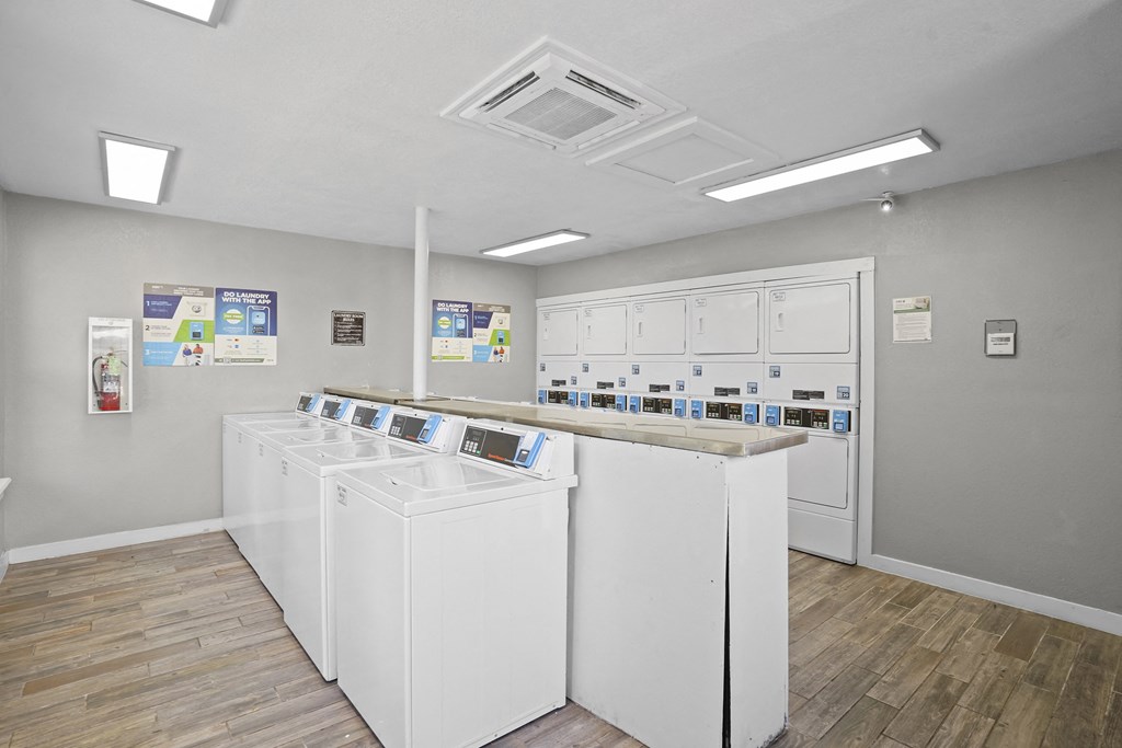 A laundromat with rows of washers and dryers.