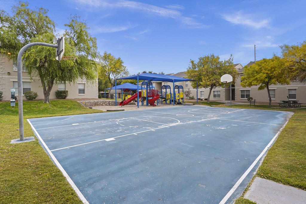 A basketball court with a blue sky in the background.