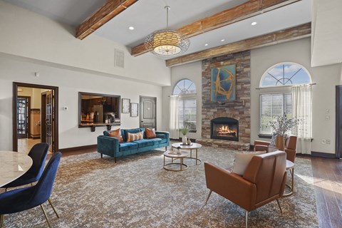 A living room with a fireplace and a blue couch.