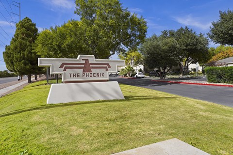 a sign for the phoenix at the corner of a street
