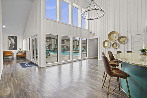 A large room with a pool and a bar.