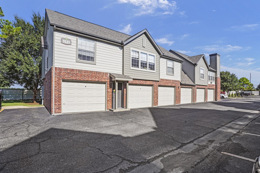 A row of houses with garages and driveways.