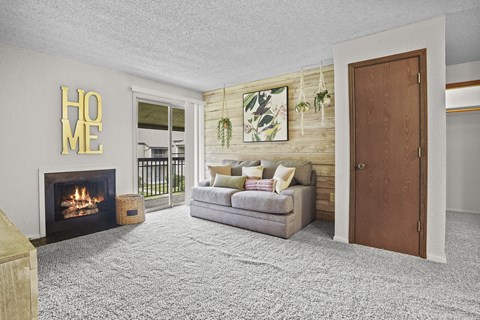 A living room with a fireplace and a couch.