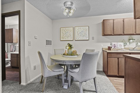 A dining room with a table set for two.