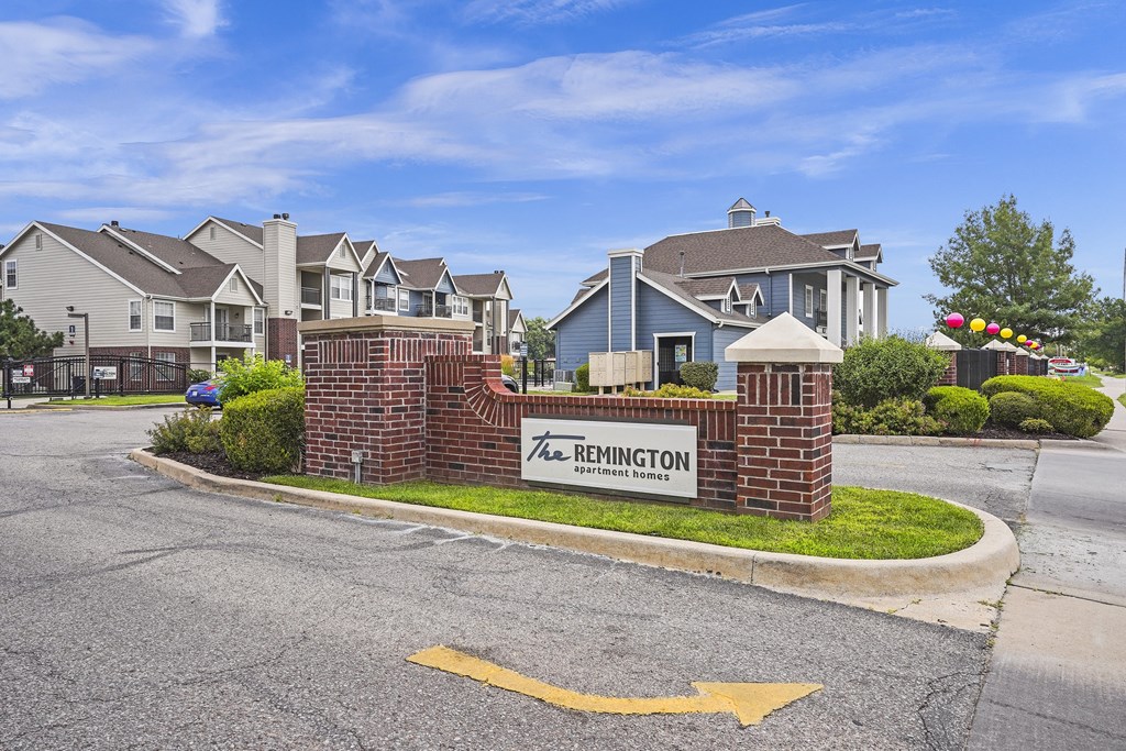 The Remington sign is in front of a brick wall.