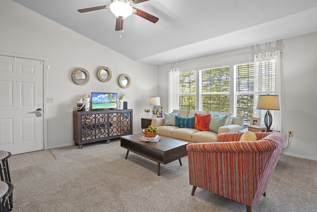A living room with a striped couch and a coffee table.