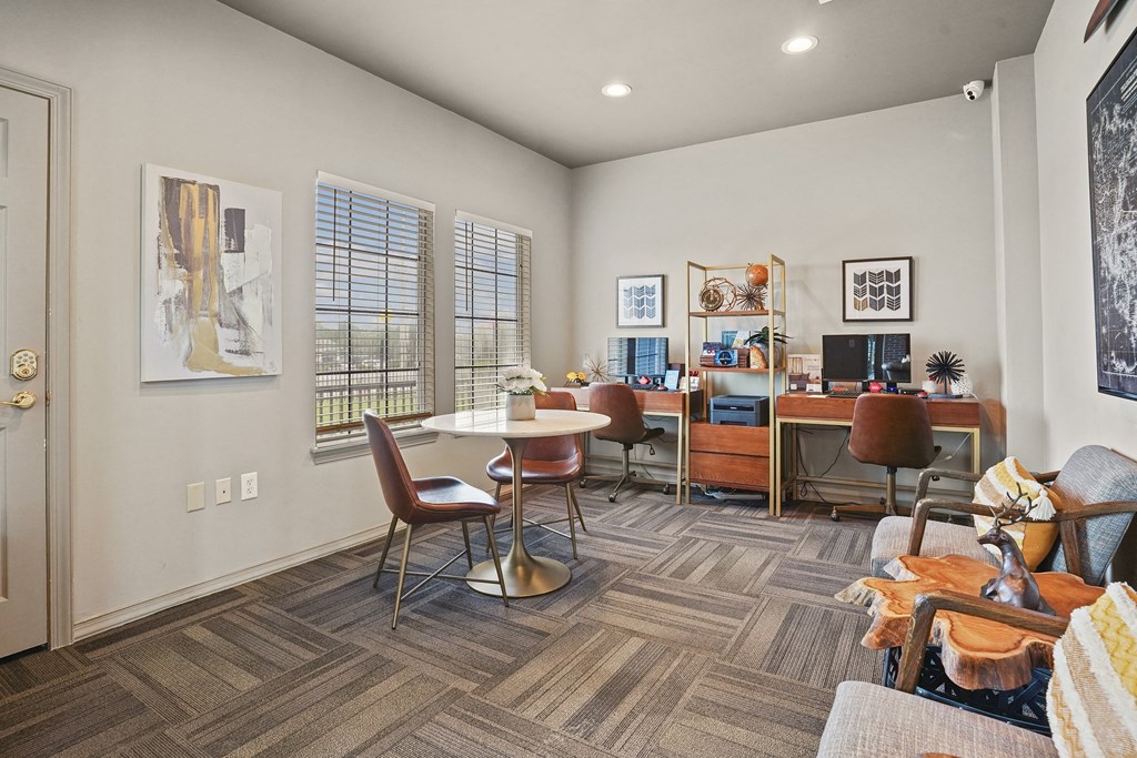 A living room with a couch, chairs, and a dining table.