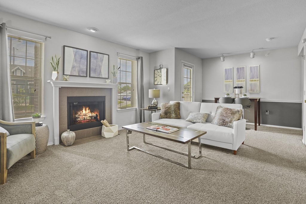 A living room with a fireplace and a white couch.