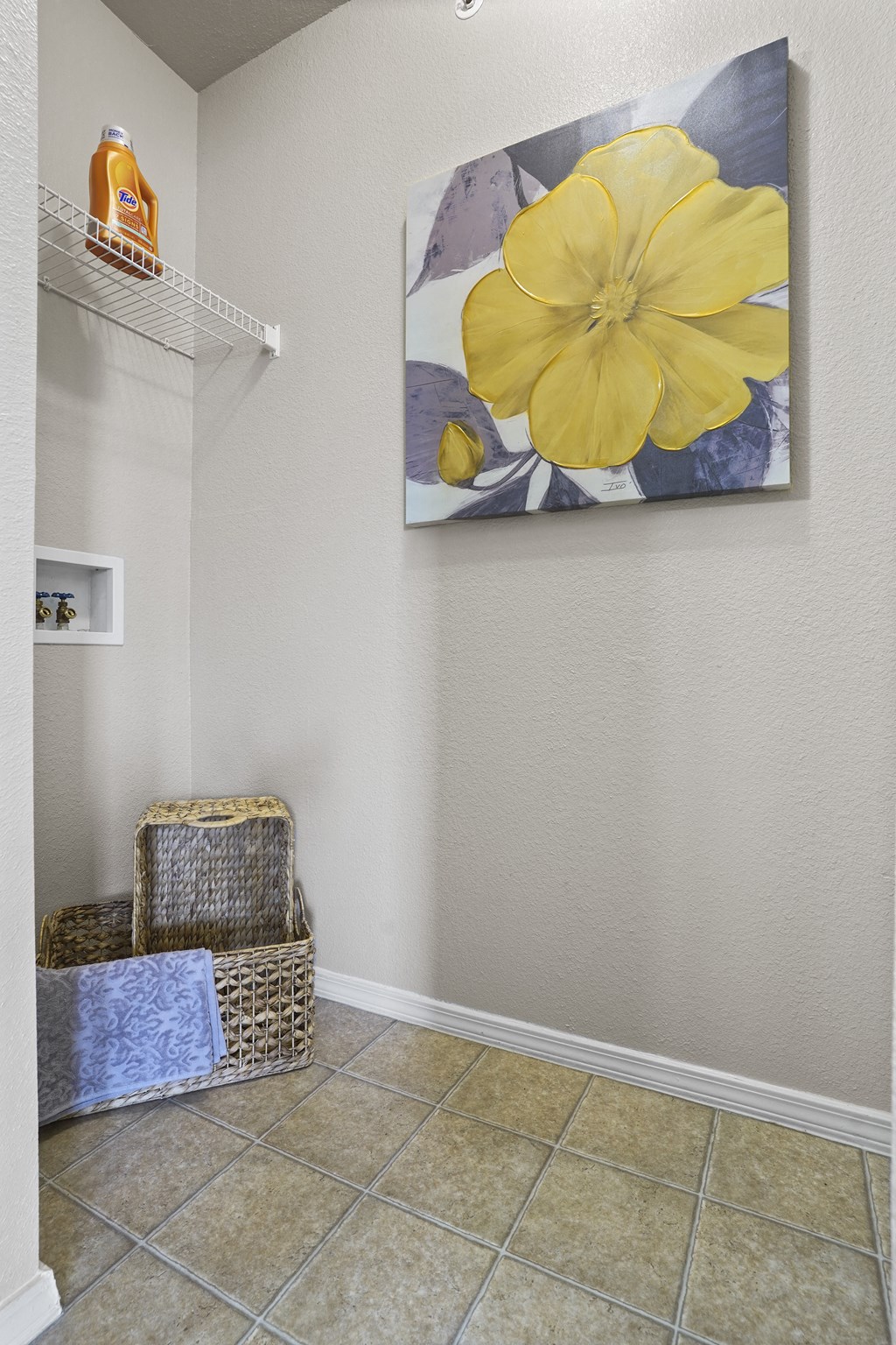 A yellow flower is painted on a canvas.