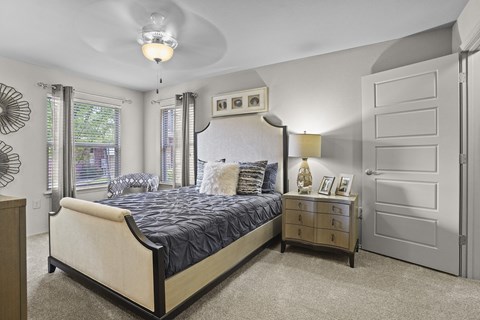 A bedroom with a large bed and a dresser.