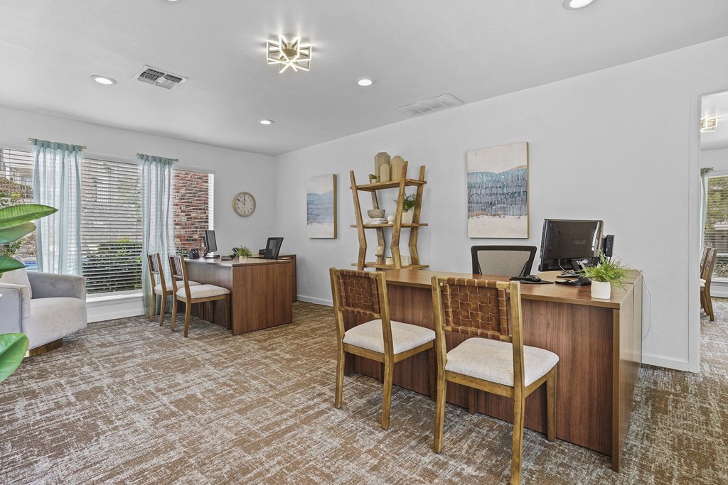 A room with a desk and chairs.