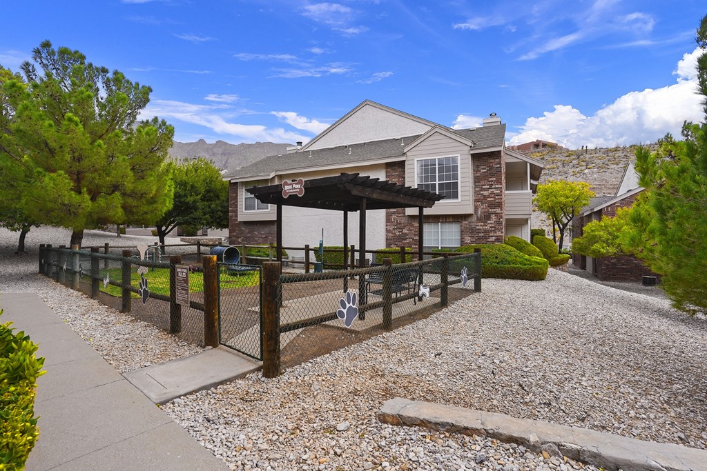 A house with a gravel driveway and a fence.