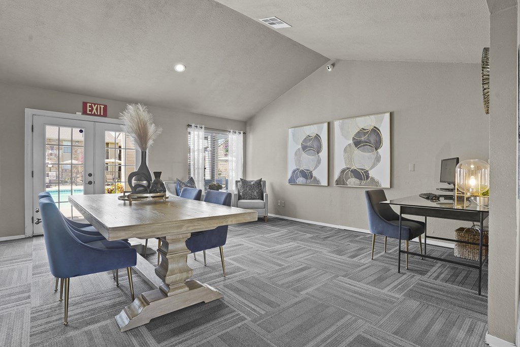 A grey and blue themed dining room with a large table and chairs.