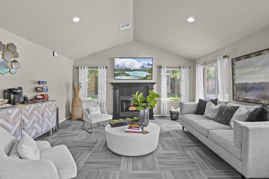 A modern living room with a fireplace and a large screen TV.