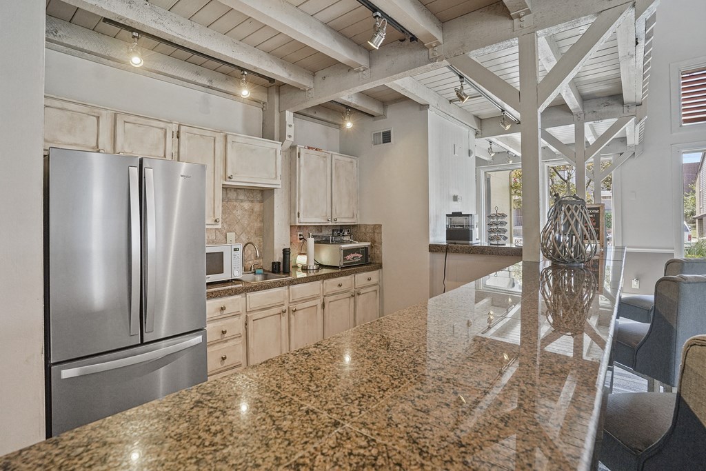 A kitchen with granite countertops and stainless steel appliances.