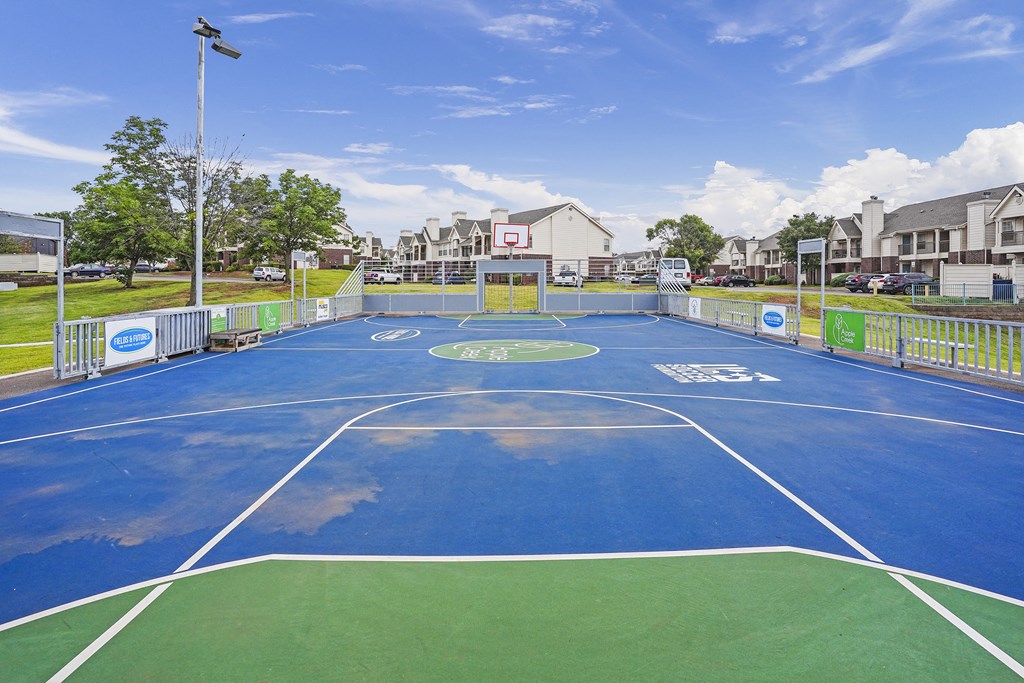 A basketball court with a blue and green surface and white lines.