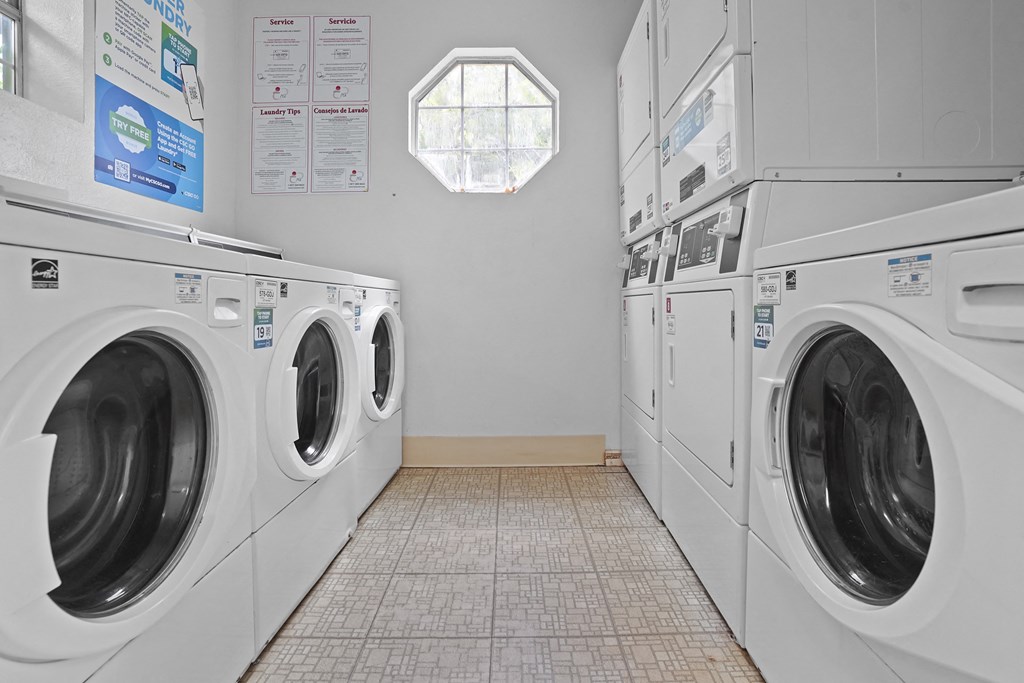 A row of washing machines in a laundromat.