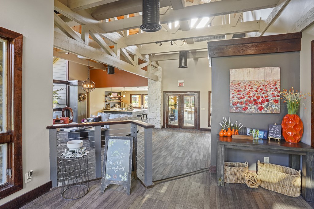 A kitchen with a wooden floor and a large island with a bar.