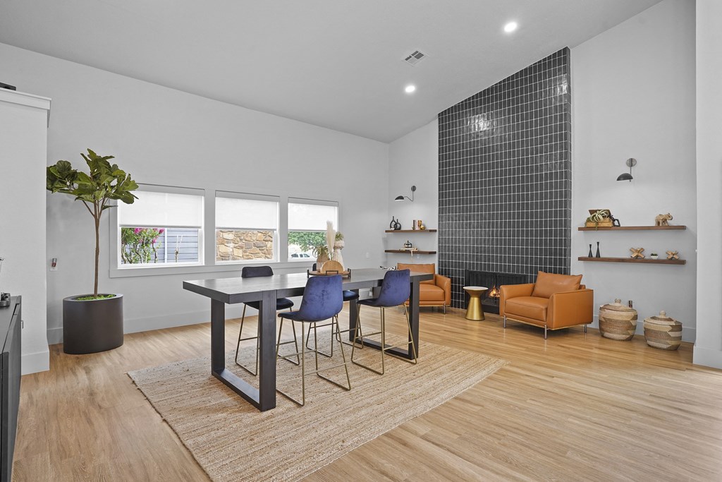 A modern dining room with a glass table and chairs.