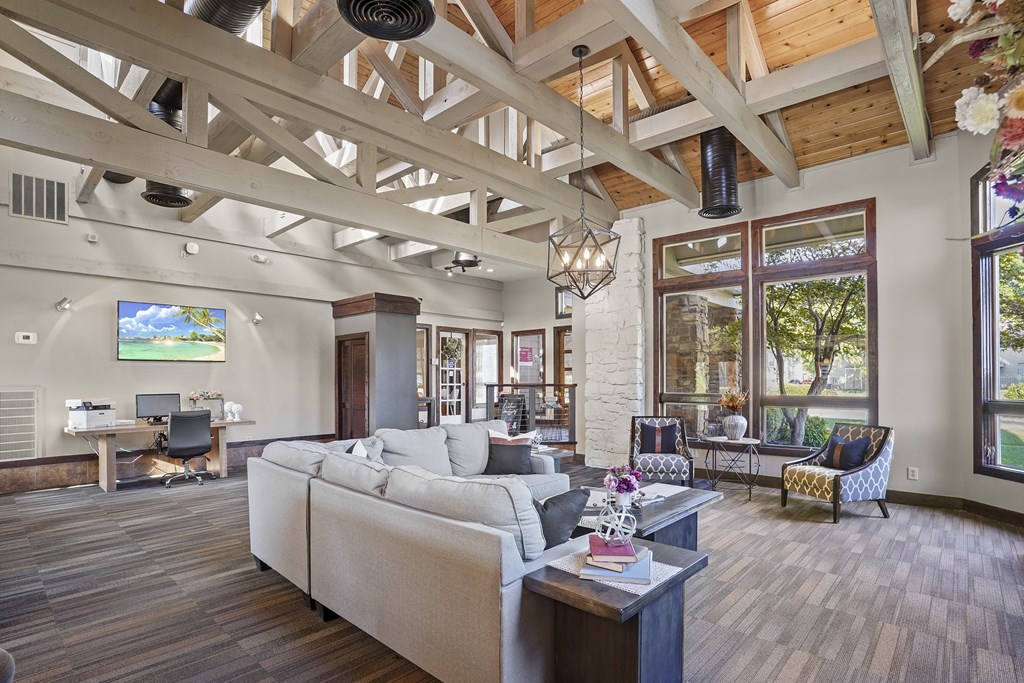 A living room with a couch, a television, and a window.