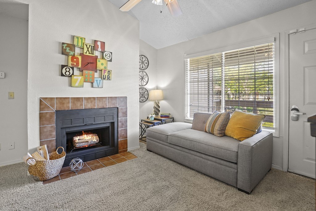 A living room with a fireplace and a couch.
