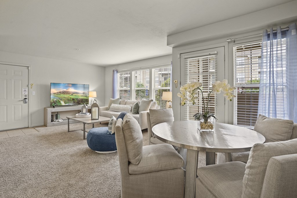 A living room with a white table and chairs.