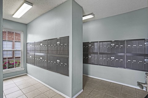 A room with a row of mailboxes on the wall.