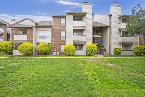 Apartment building with a green lawn in front.