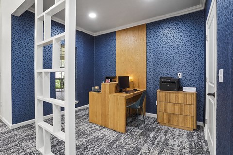 A room with a desk and a printer.