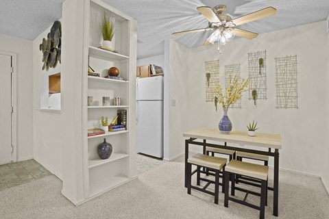 A white kitchen with a table and chairs.