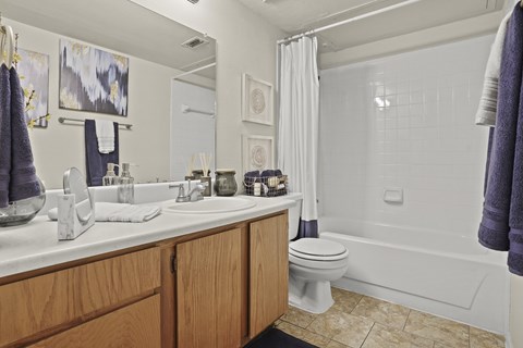 A bathroom with a white sink and a white toilet.