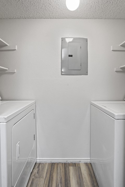 A white bathroom with a toilet and a mirror.