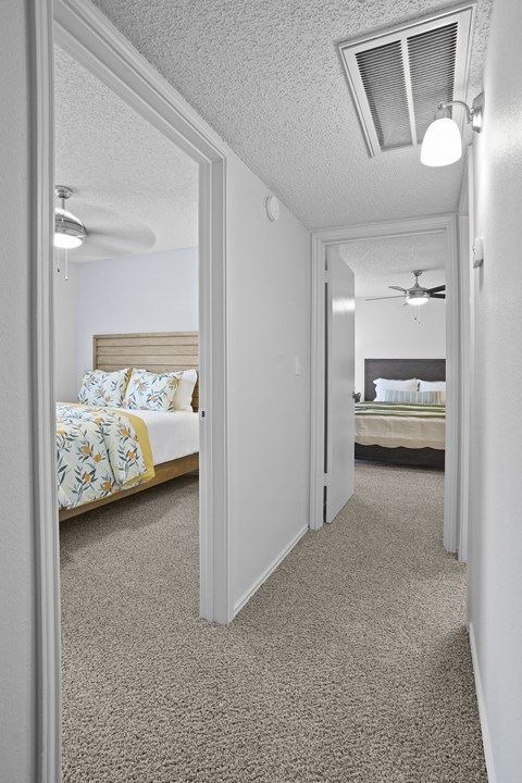 A bedroom with a bed and a ceiling fan.