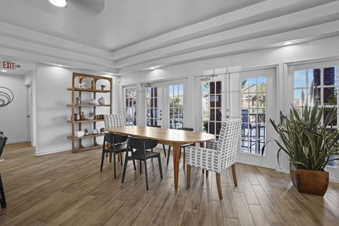 A dining room with a wooden table and chairs.