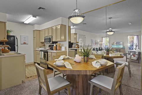 A modern kitchen with a dining table set for two.