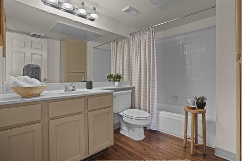 A bathroom with a white toilet and a wooden stool.