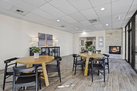 A dining room with a wooden table and chairs.