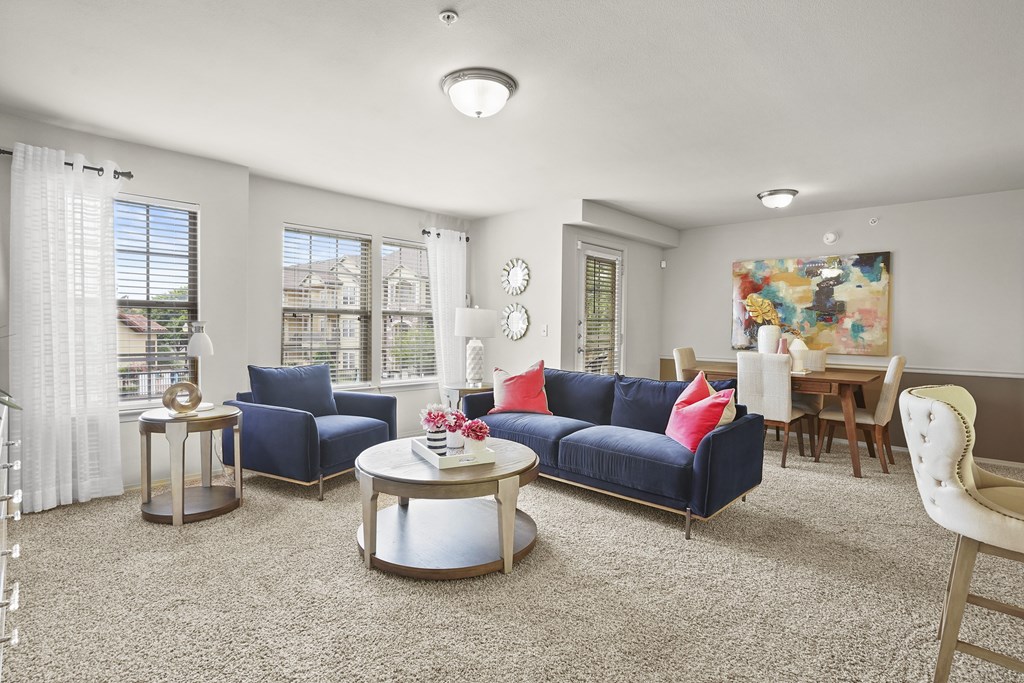 A living room with a blue couch and a coffee table.