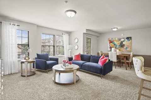 A living room with a blue couch and a coffee table.