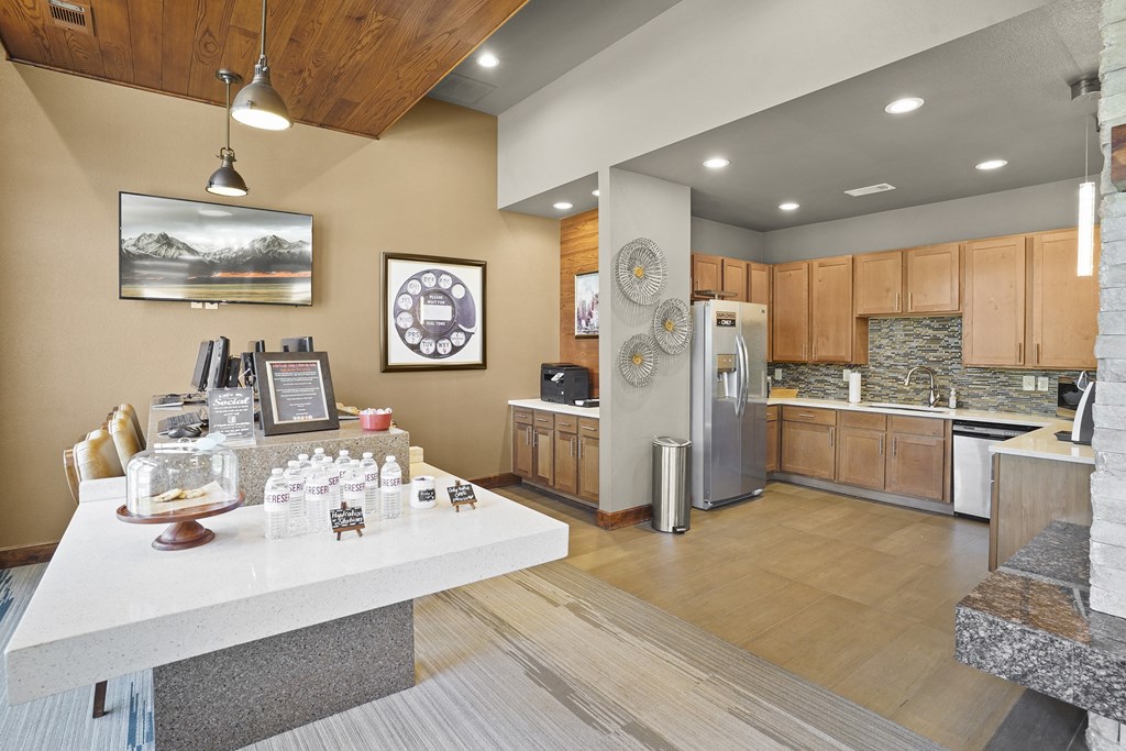 A reception area with a desk and a framed picture of a mountain landscape on the wall.