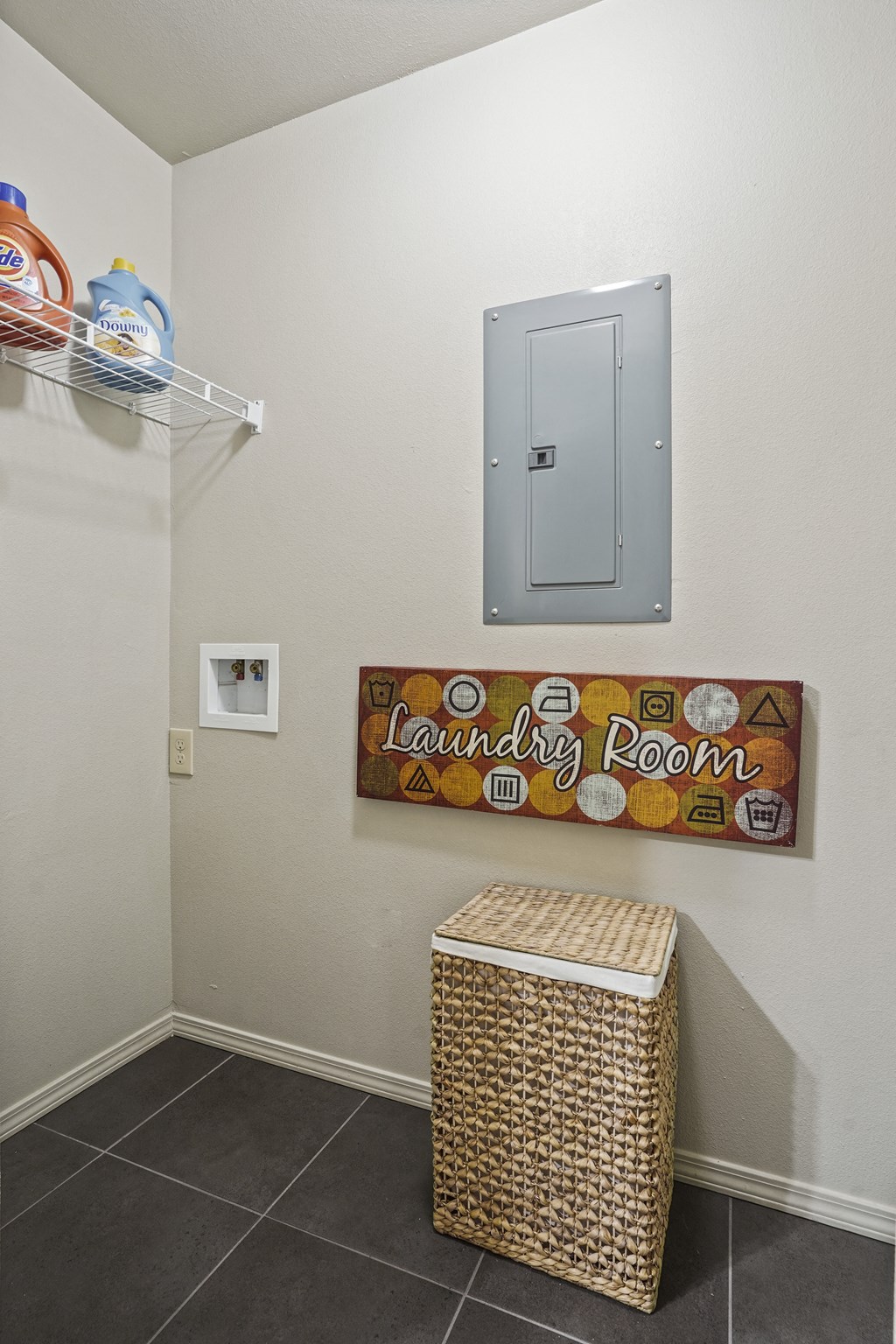 Laundry room with a basket and a sign.