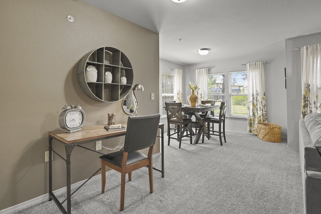 A dining room with a table and chairs.